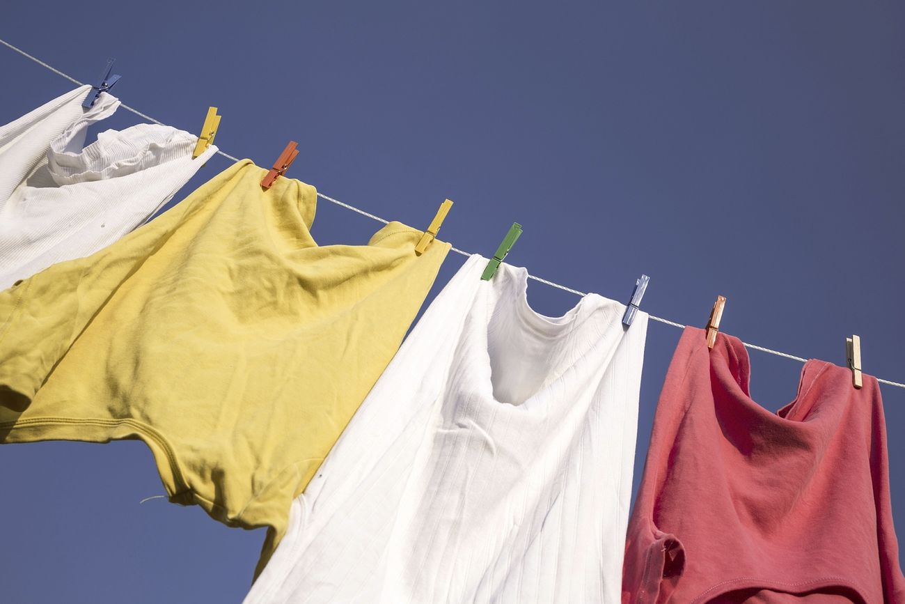 Clothes hanging against blue sky