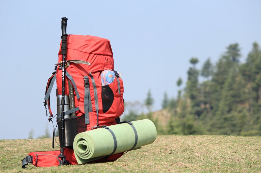 red hiking backpack on grass