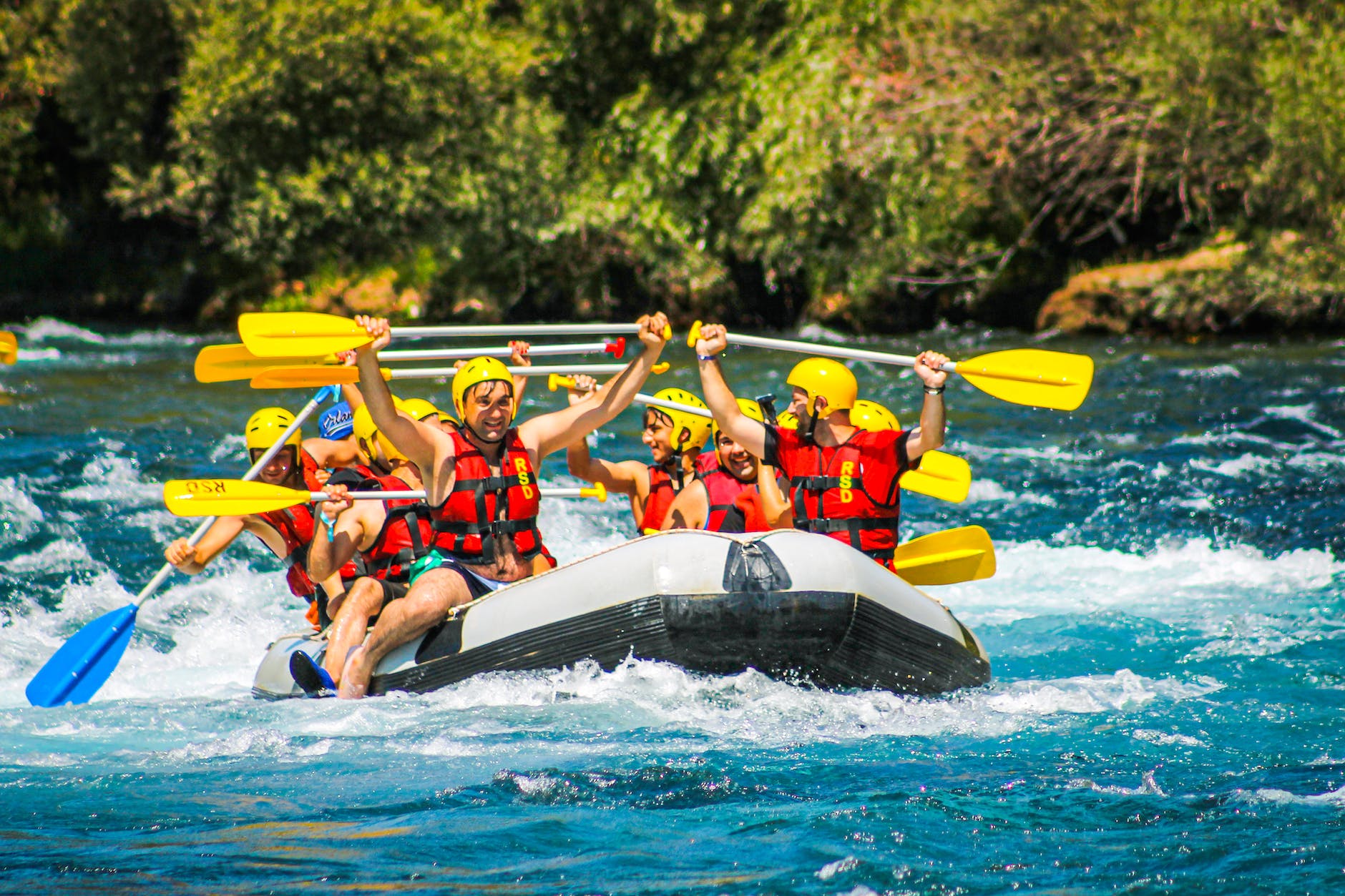 people riding on inflatable raft