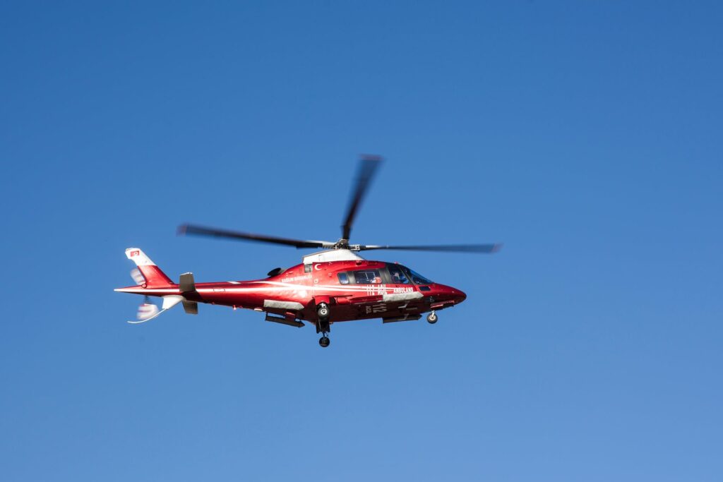 flying red and white helicopter