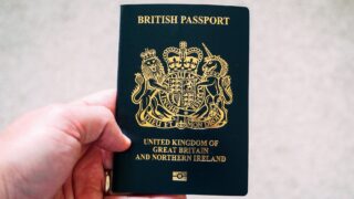 crop unrecognizable person demonstrating british passport