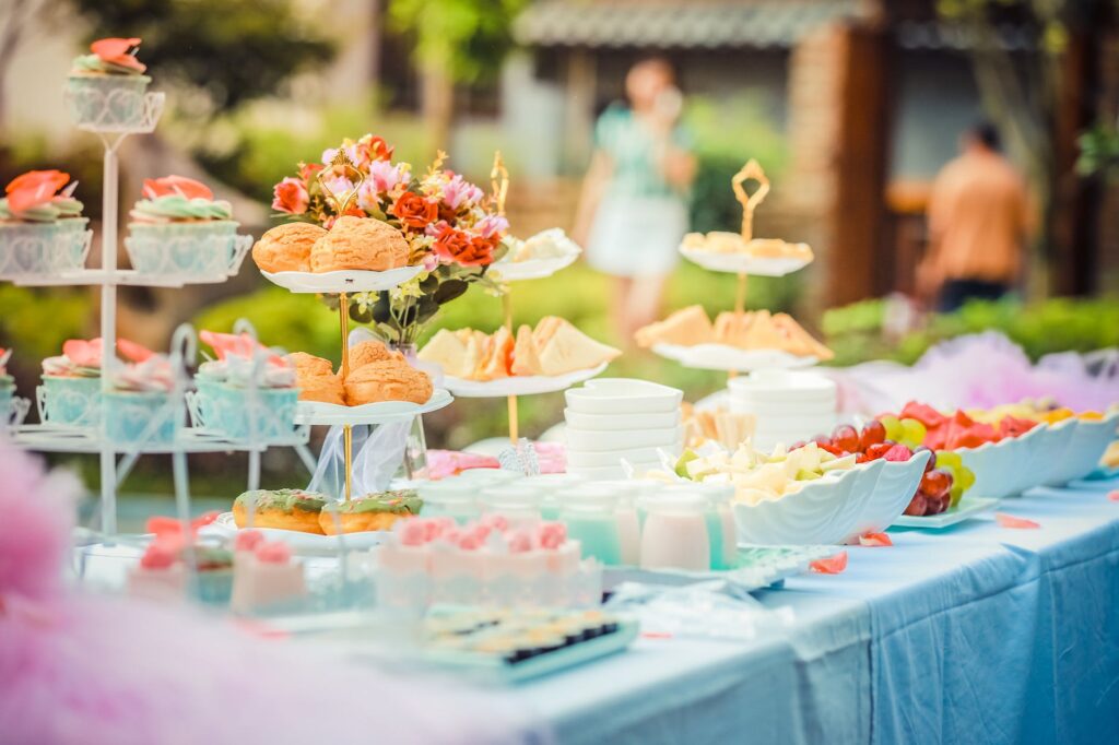 various desserts on a table covered with baby blue cover