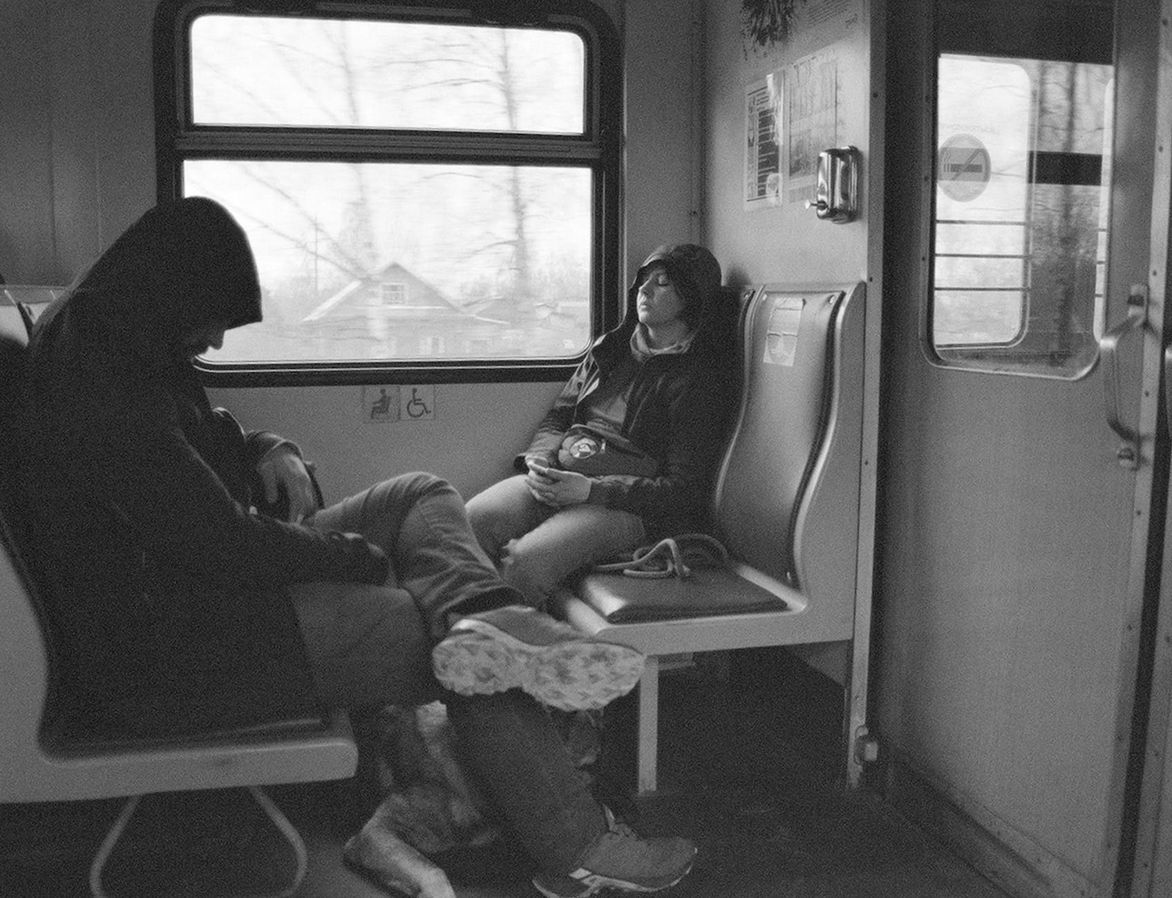 woman and man sleeping on train