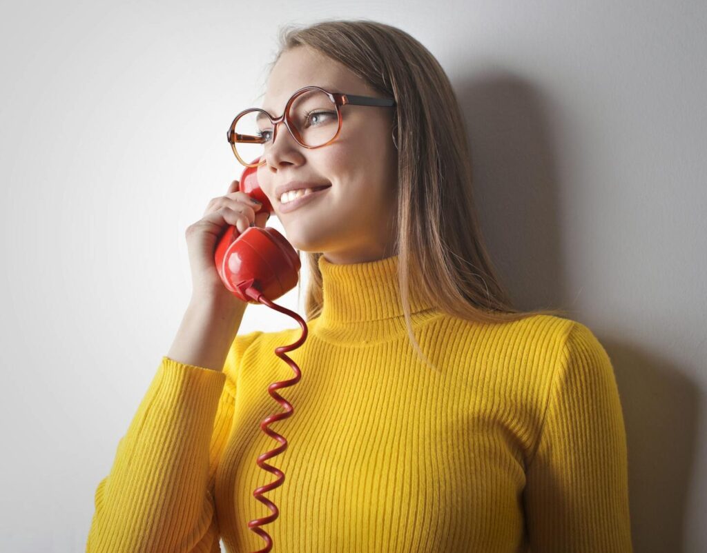 woman holding a telephone