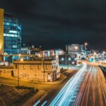 illuminated night city with traffic on street