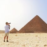 man taking photo of the great pyramid