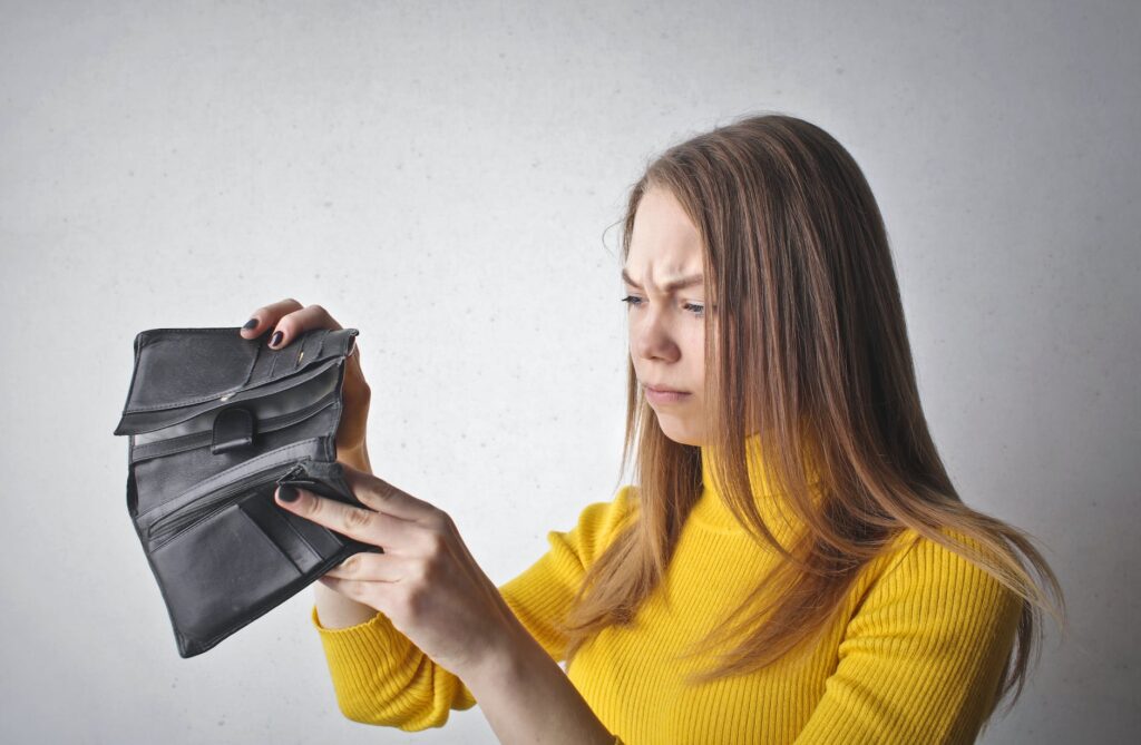 woman holding black wallet