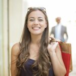 woman in black tank top smiling