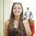 woman in black tank top smiling