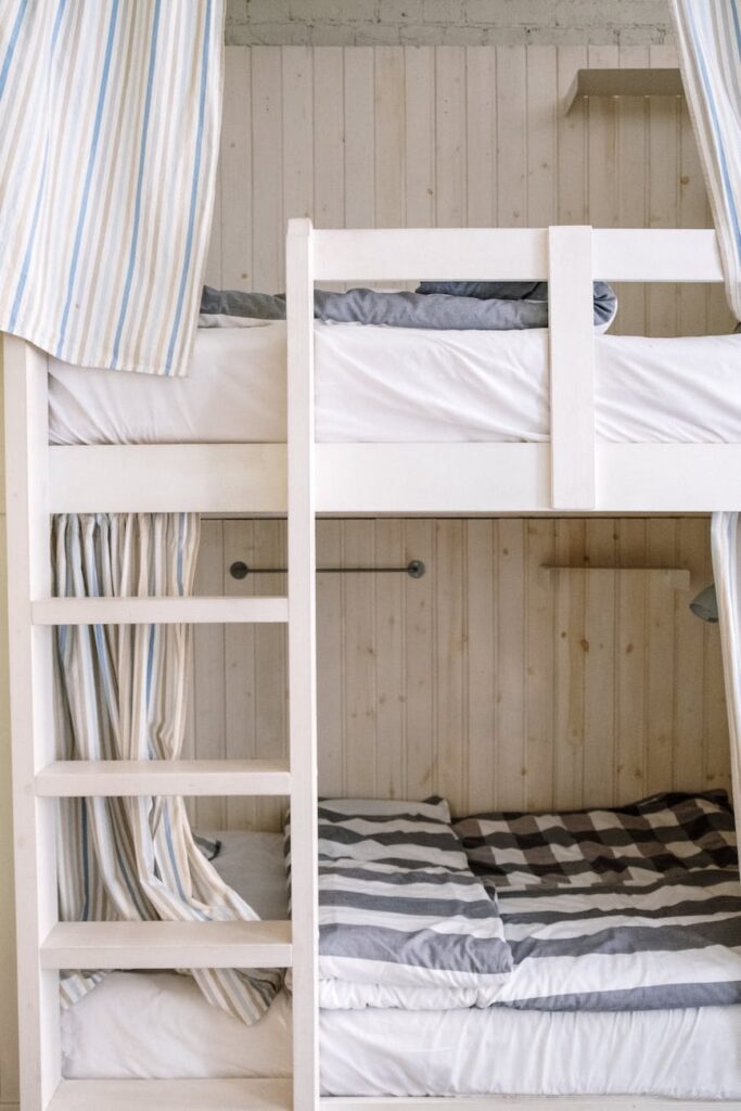 white and blue striped dress shirt on white wooden bunk bed