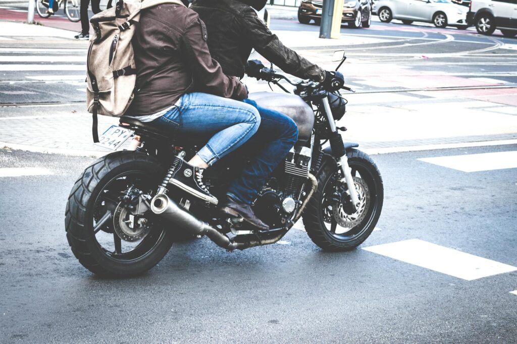 two person riding gray cafe racer