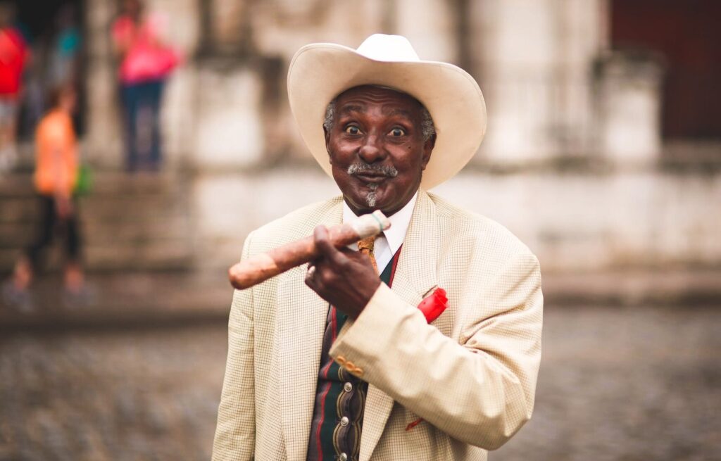 elderly ethnic businessman with cigar on city street