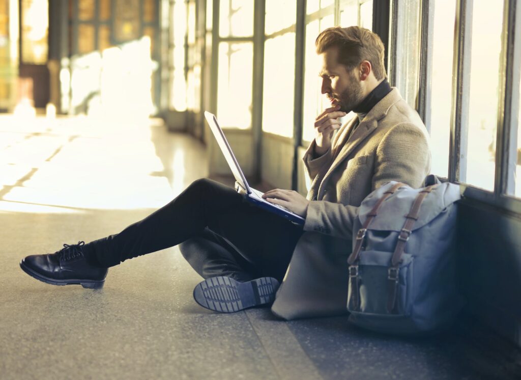 brown haired man using laptop computer