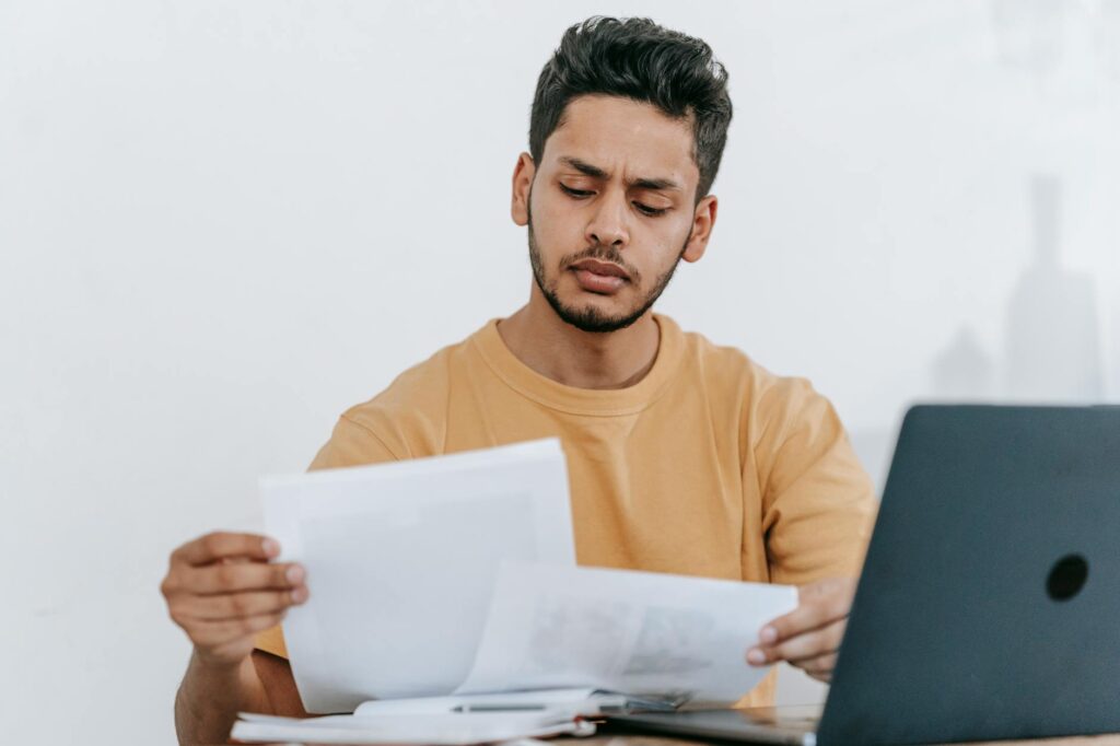 man looking through documents at workplace