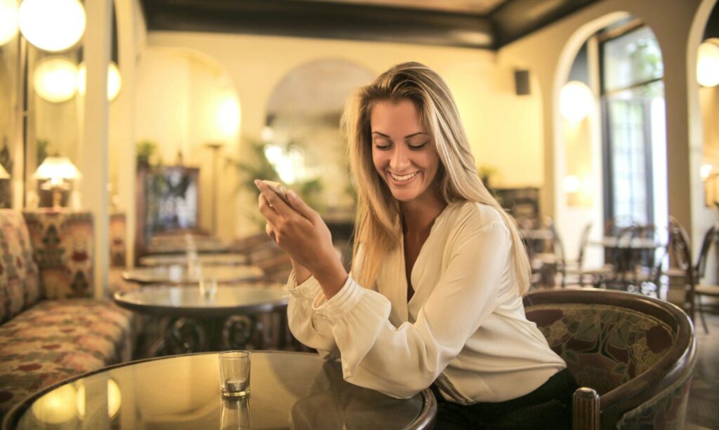 cheerful female having drink in elegant bar